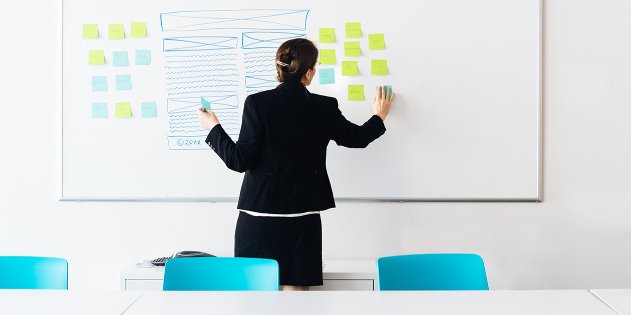 business woman with sticky notes on a whiteboard