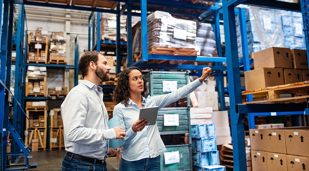 Manager and supervisor taking inventory in the warehouse