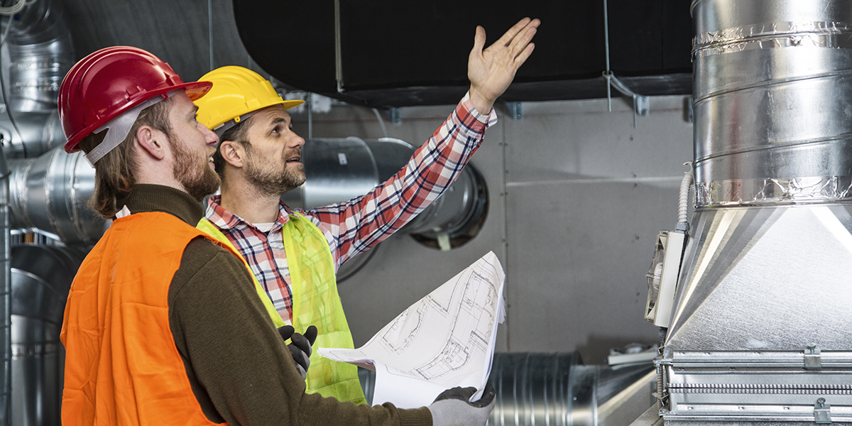 HVAC Engineers reviewing equipment installation.