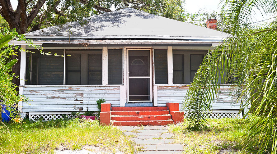 an older house with peeling paint