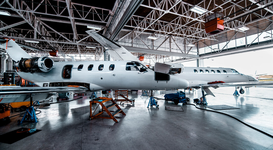 private planes in a maintenance hangar